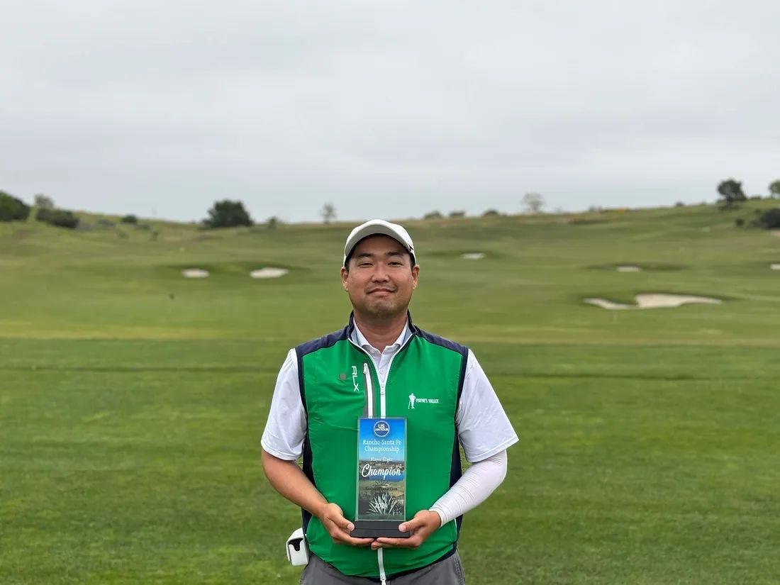 Tony holding the champion's plaque on the course