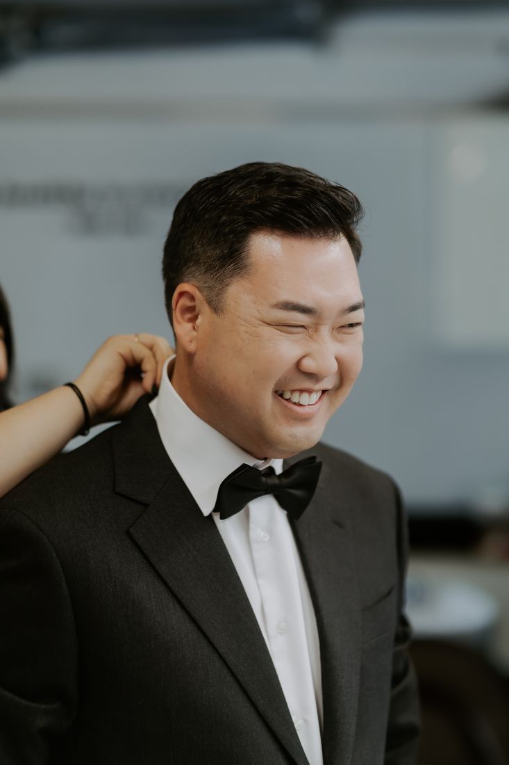 Tony laughing in a tuxedo